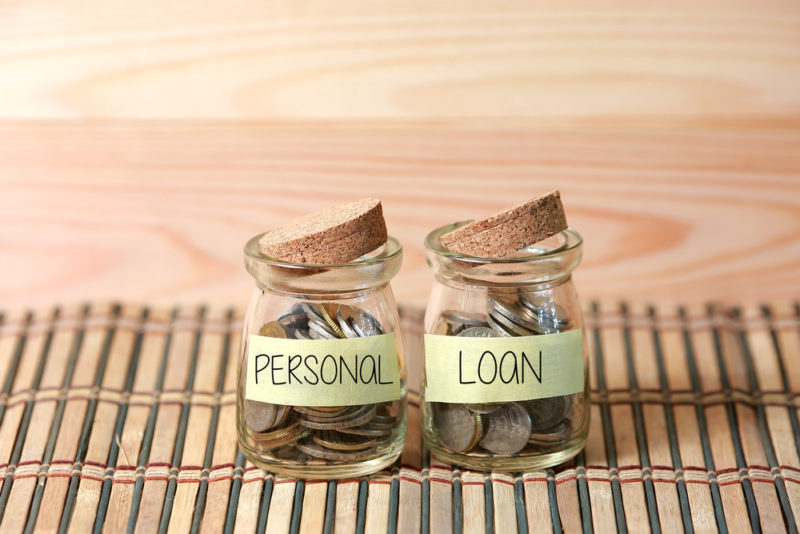 Personal Loan on two jar with wooden pallet background